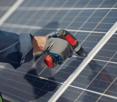 man-with-white-helmet-near-solar-panel